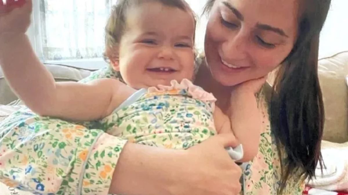 A mom holding her smiling baby