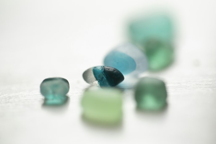 Teal sea glass on the sand
